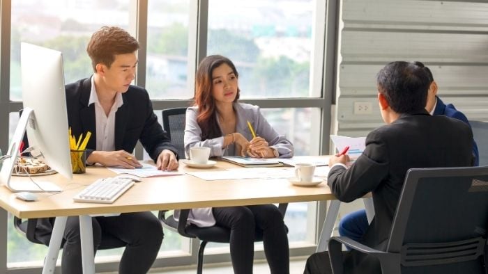 asian employees discussing